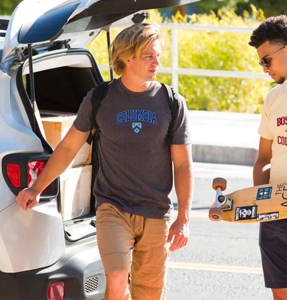 two boys with skate board wearing columbia and boston college t-shirts