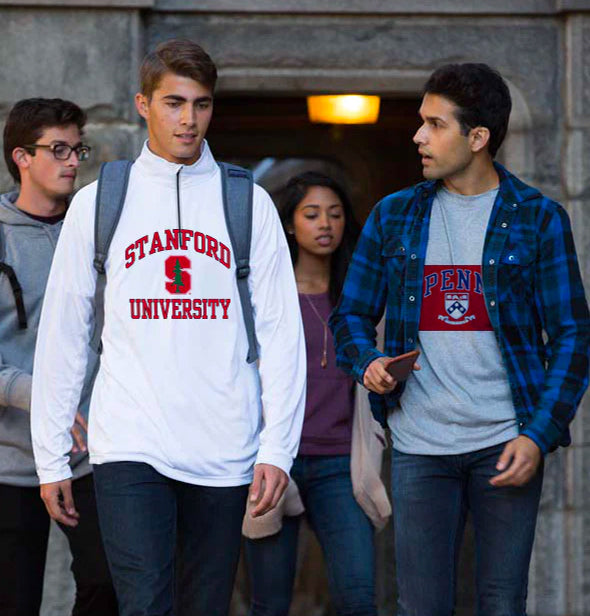 A Group of students Walking in front of a Building with stanford sweatshirts