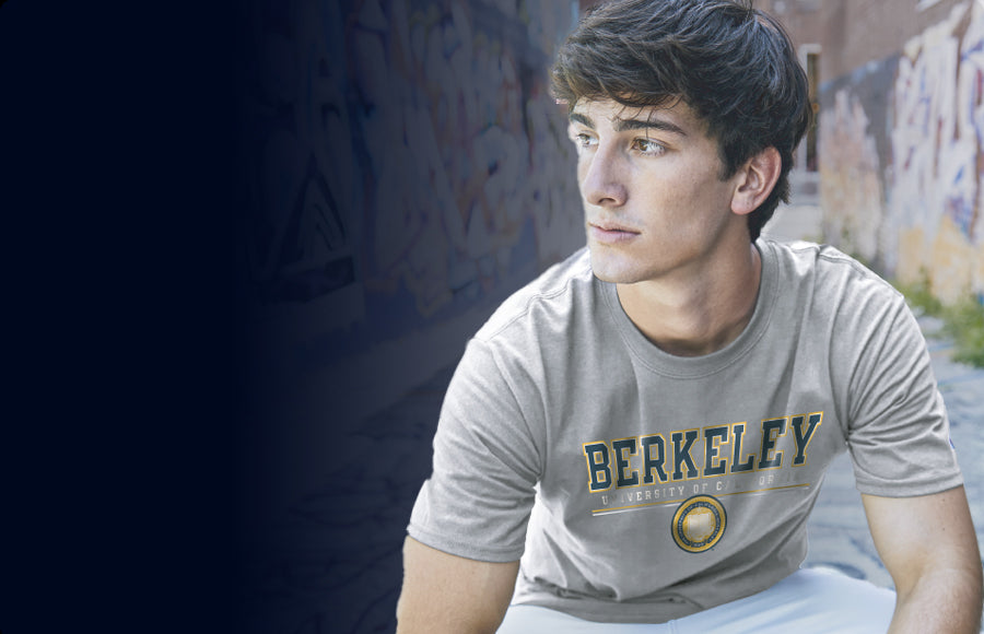 A boy wearing a gray t-shirt with UC BERKELEY logo