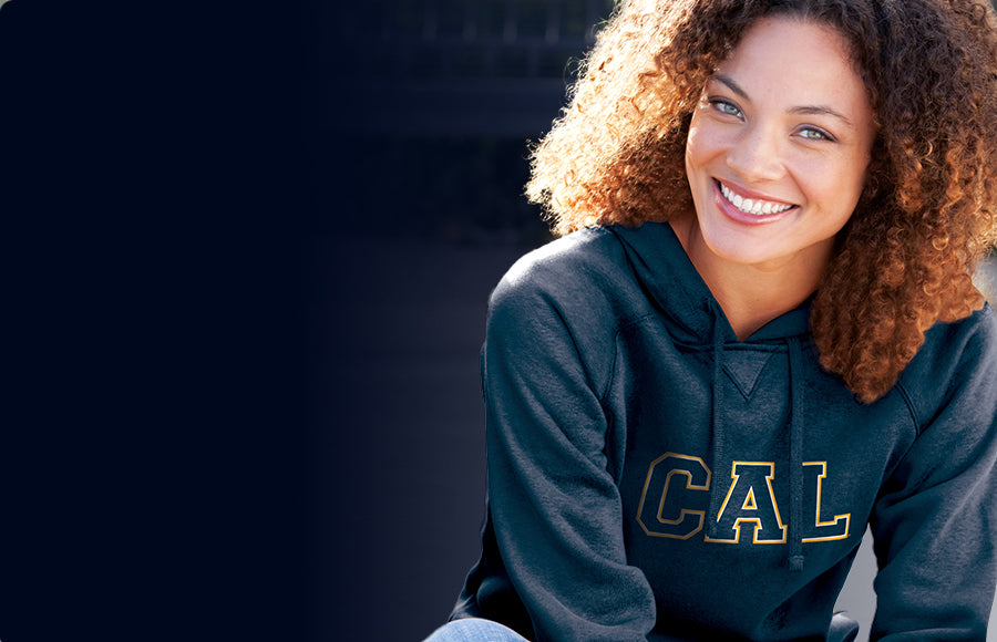 A girl wearing a CAL Navy sweatshirt 